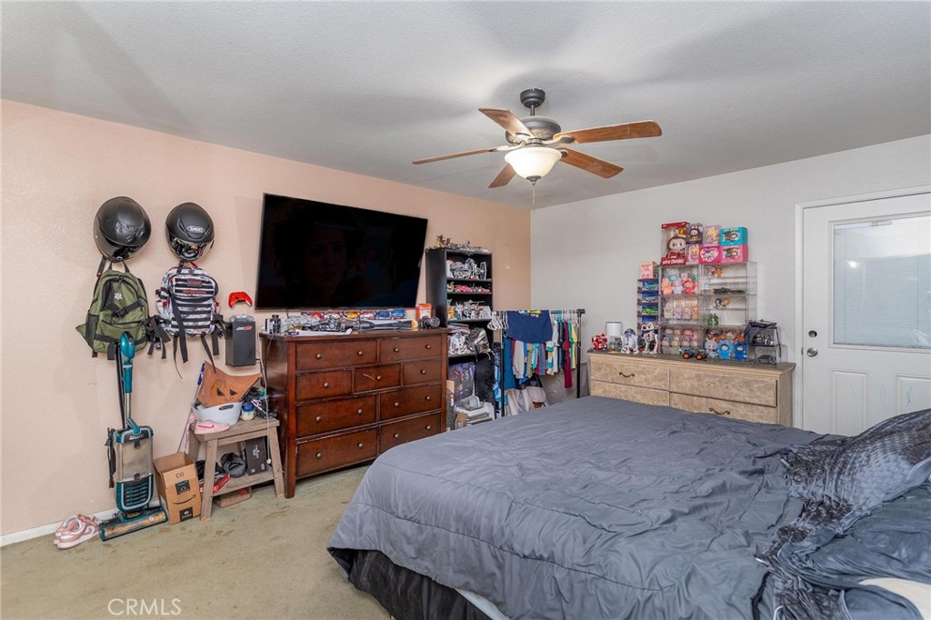 81901 Victoria Street Indio, CA 92201 - Photo 15 of 29 a bedroom with furniture and a flat screen tv