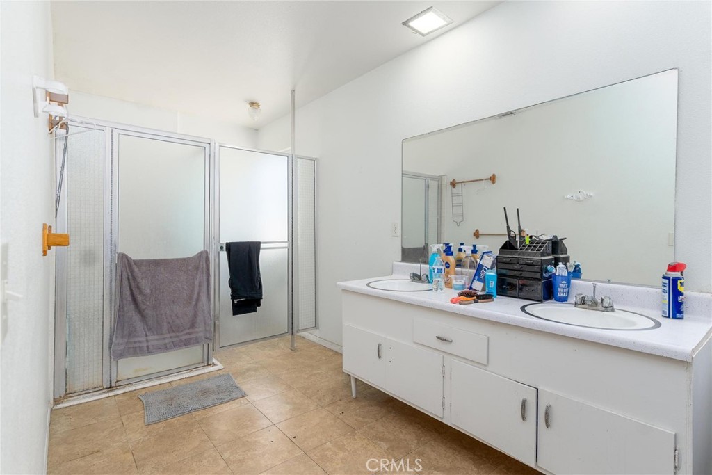 81901 Victoria Street Indio, CA 92201 - Photo 16 of 29 a bathroom with a double vanity sink and mirror