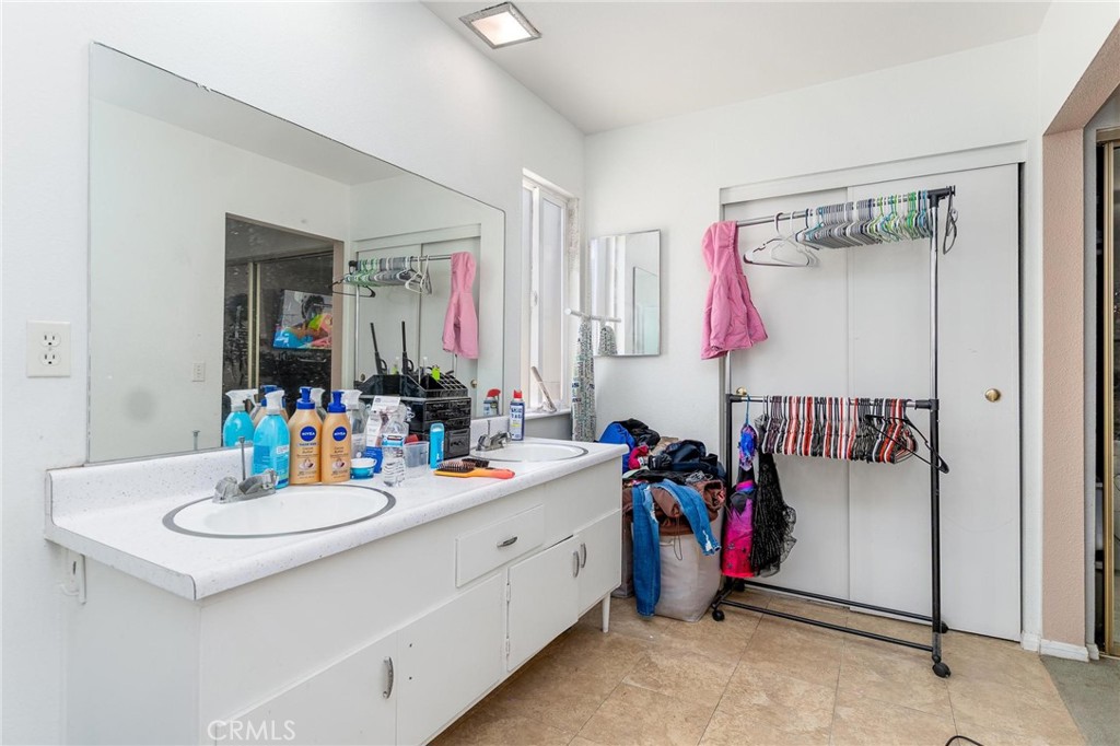81901 Victoria Street Indio, CA 92201 - Photo 17 of 29 a bathroom with a double vanity sink mirror and shower