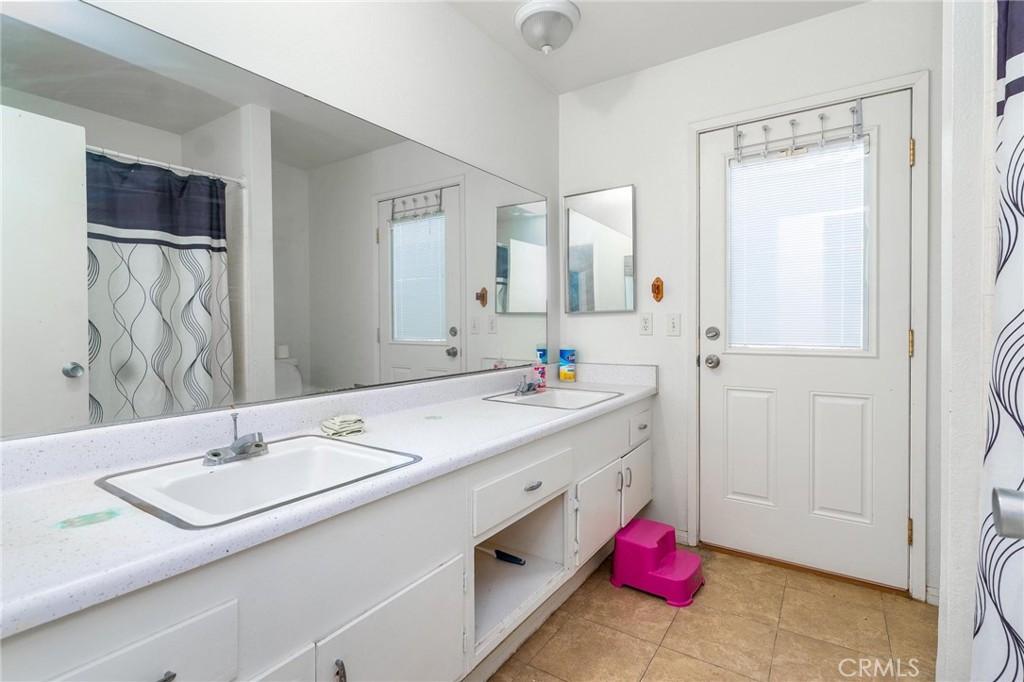 81901 Victoria Street Indio, CA 92201 - Photo 21 of 29 a bathroom with a sink double vanity and a mirror