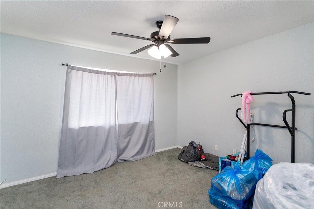 81901 Victoria Street Indio, CA 92201 - Photo 25 of 29 a room with gym equipment and a chandelier