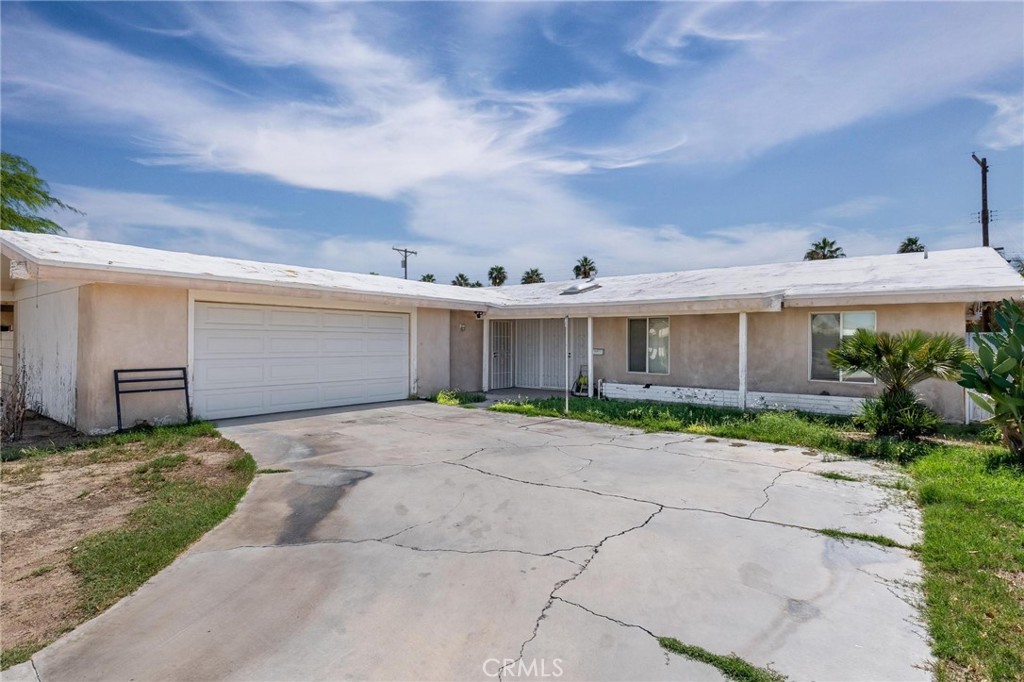 81901 Victoria Street Indio, CA 92201 - Photo 4 of 29 a view of a house with a yard and garage