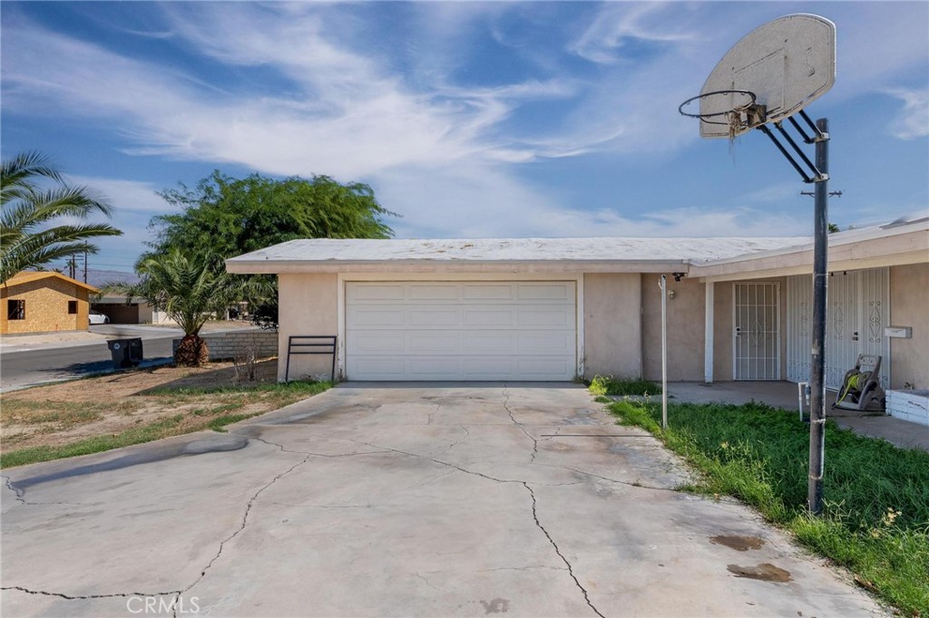 81901 Victoria Street Indio, CA 92201 - Photo 5 of 29 a view of a house with a yard and garage