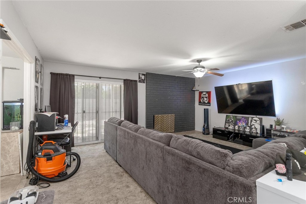 81901 Victoria Street Indio, CA 92201 - Photo 7 of 29 a living room with furniture and a flat screen tv