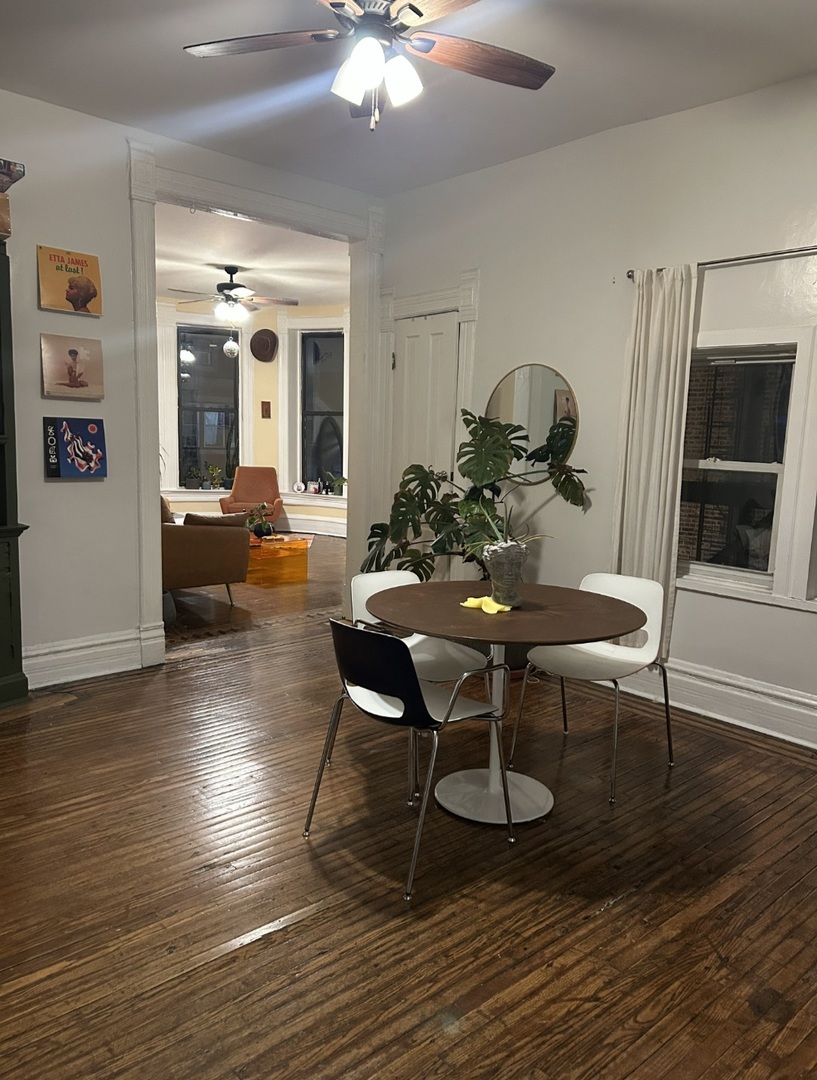 1332 West 18th Street, Unit 3F Chicago, IL 60608 - Photo 5 of 5 a dining room with furniture a chandelier and wooden floor