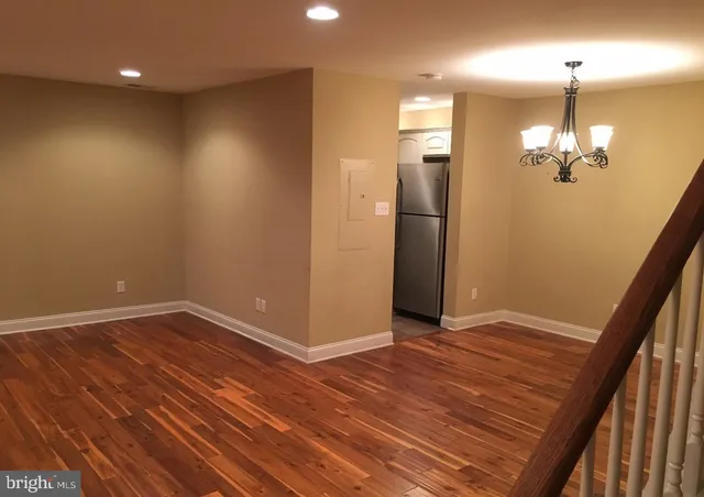 an empty room with wooden floor