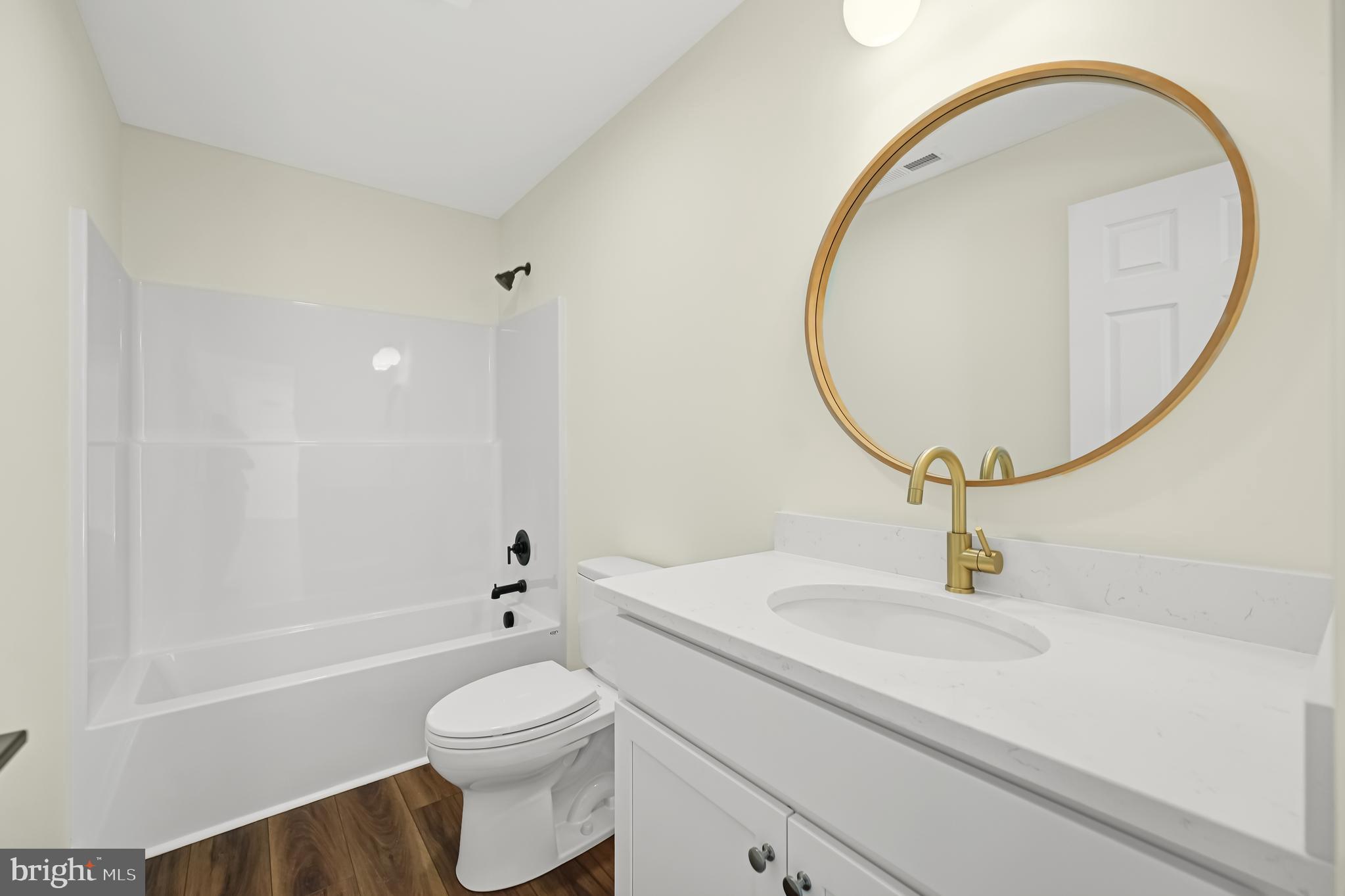 1410 Cedar Run Pocomoke City, MD 21851 - Photo 11 of 13 a bathroom with a sink a toilet and a mirror