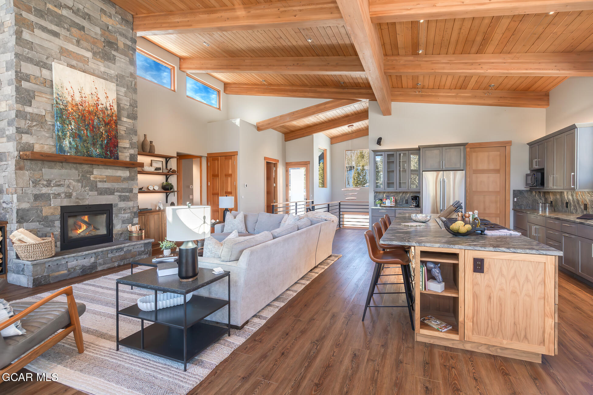 684 Vasquez Road Winter Park, CO 80482 - Photo 11 of 45 a living room with furniture wooden floor and a fireplace