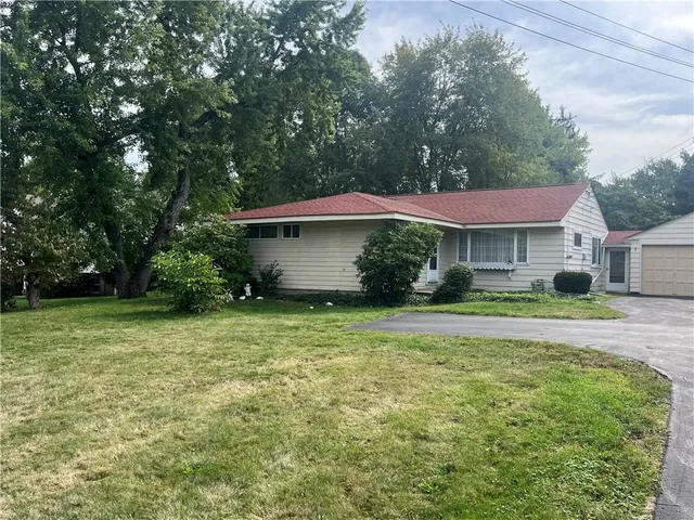 a view of a house with a yard and tree s