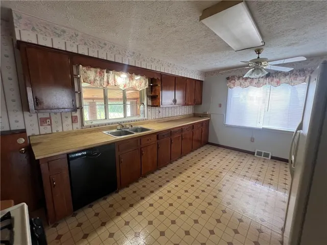 a kitchen with stainless steel appliances a sink stove and cabinets