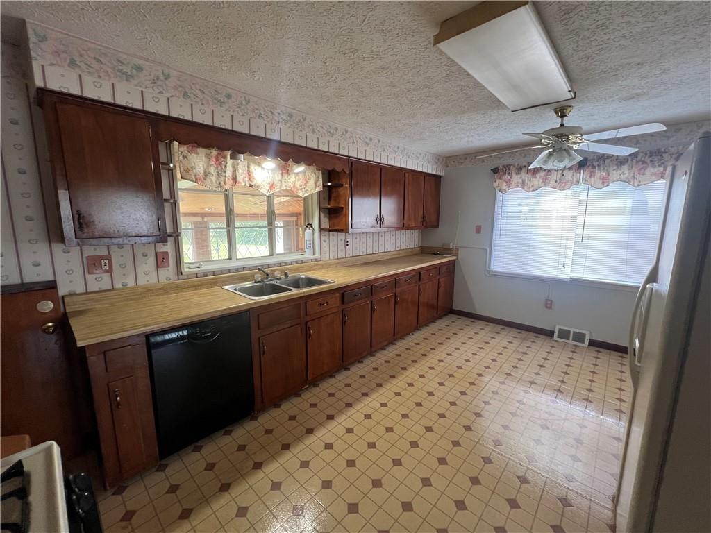 455 Tuscarawas Road Beaver, PA 15009 - Photo 4 of 18 a kitchen with stainless steel appliances a sink stove and cabinets
