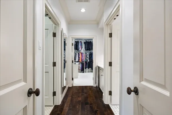 a front view of a house with garden and trees