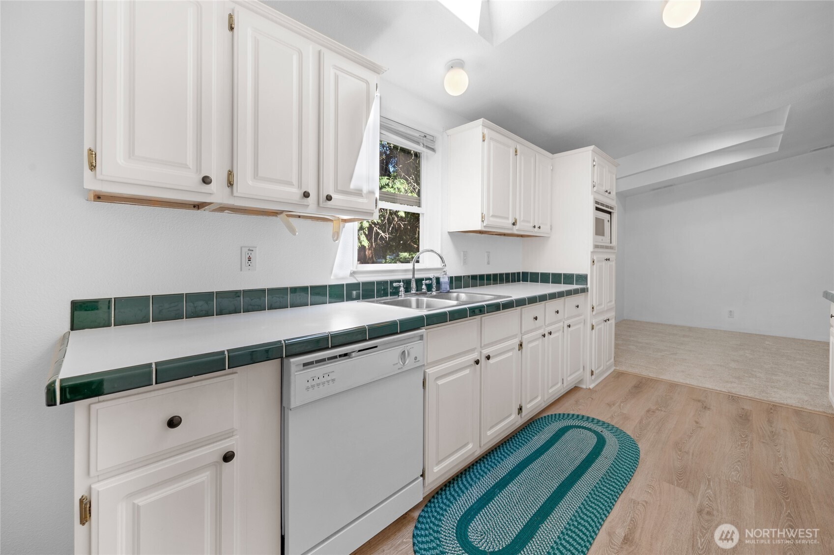 22222 49th Avenue Southeast Bothell, WA 98021 - Photo 8 of 37 a kitchen with granite countertop white cabinets and sink