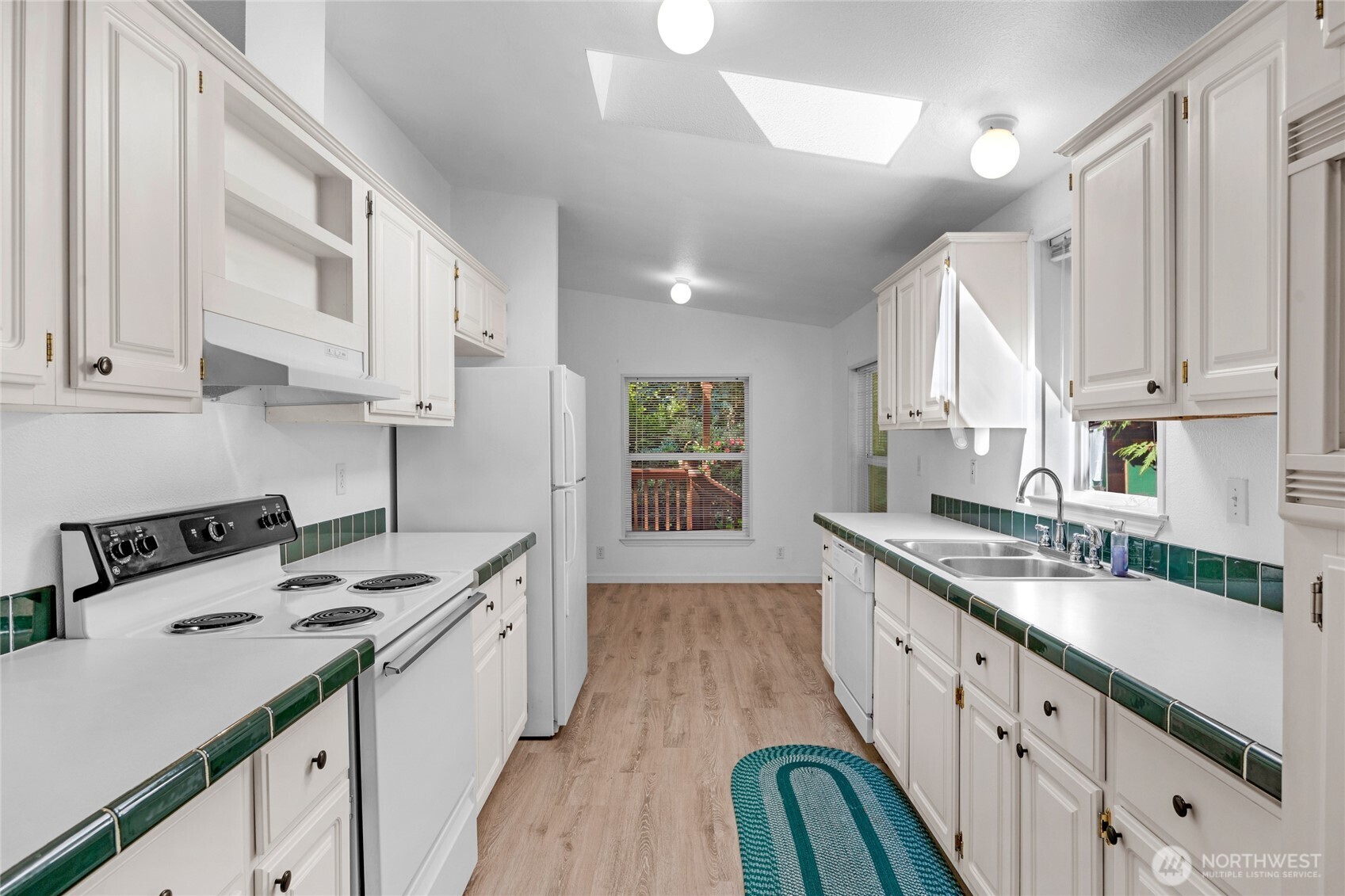 22222 49th Avenue Southeast Bothell, WA 98021 - Photo 9 of 37 a kitchen with a sink stove and cabinets