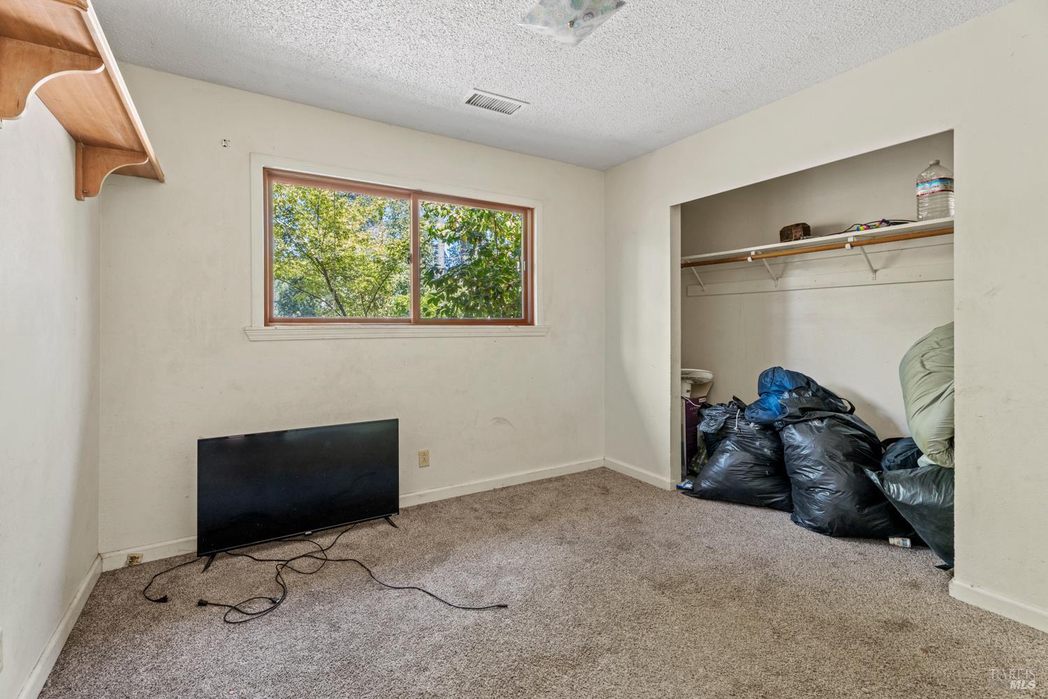 3781 Ridgewood Road Willits, CA 95490 - Photo 13 of 18 a room with a flat tv screen and a rug