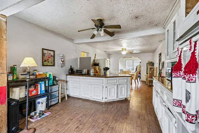 a large living room with furniture and a wooden floor