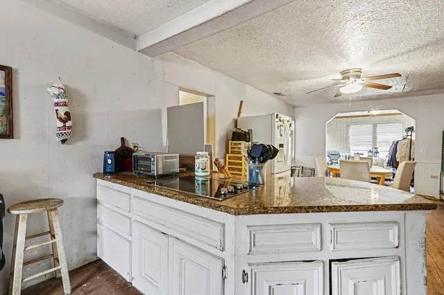 a kitchen with sink cabinets and chandelier
