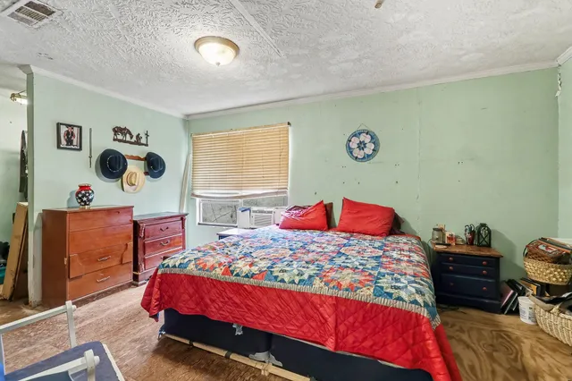 a bedroom with a bed and dresser