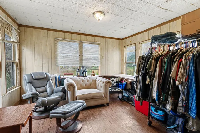 a living room with furniture a ceiling fan and a window