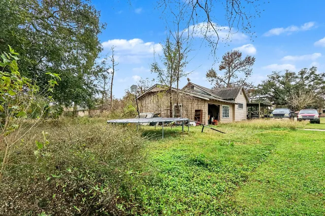 a backyard of a house with table and chairs