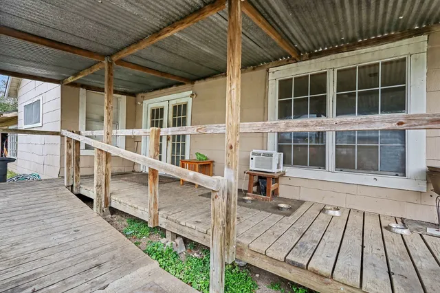 a view of balcony with wooden floor and seating