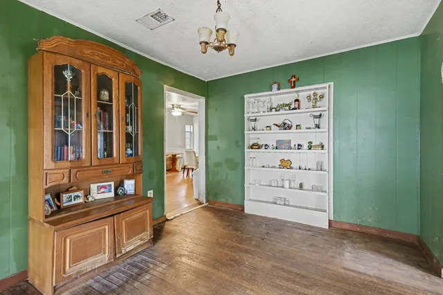 a view of a hallway with cabinet and stairs