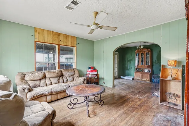 a living room with furniture and a dining table