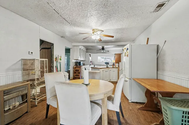 a dining room with furniture and wooden floor