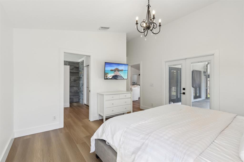 6254 Lucerne Street Jupiter, FL 33458 - Photo 14 of 30 a bedroom with a bed and wooden floor