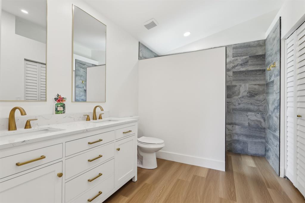 6254 Lucerne Street Jupiter, FL 33458 - Photo 15 of 30 a bathroom with a granite countertop sink toilet and shower