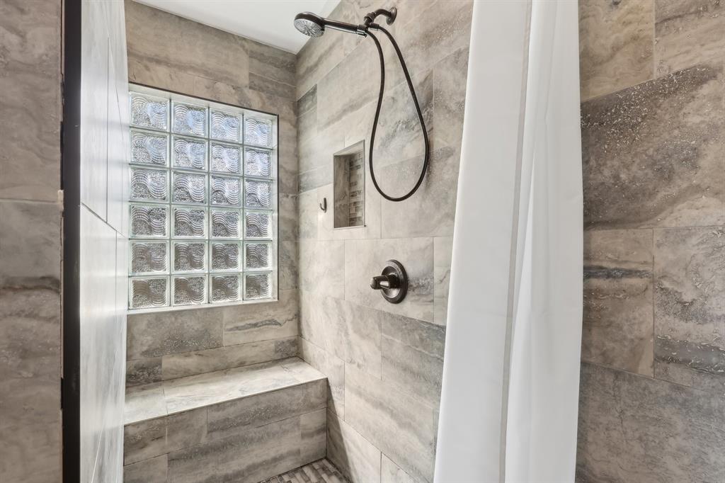 6254 Lucerne Street Jupiter, FL 33458 - Photo 17 of 30 a bathroom with a glass shower door