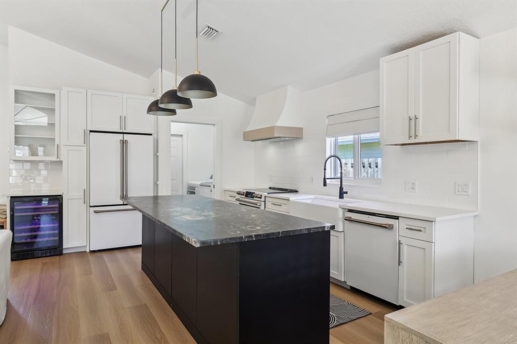 6254 Lucerne Street Jupiter, FL 33458 - Photo 10 of 30 a kitchen with stainless steel appliances granite countertop a sink stove and refrigerator