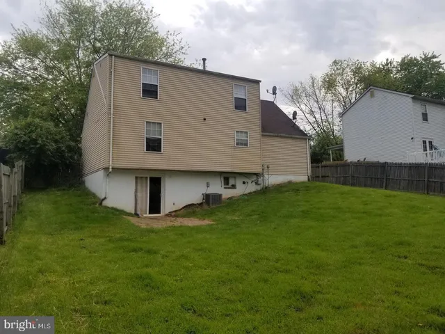 a view of backyard with barbeque grill and a small cabin