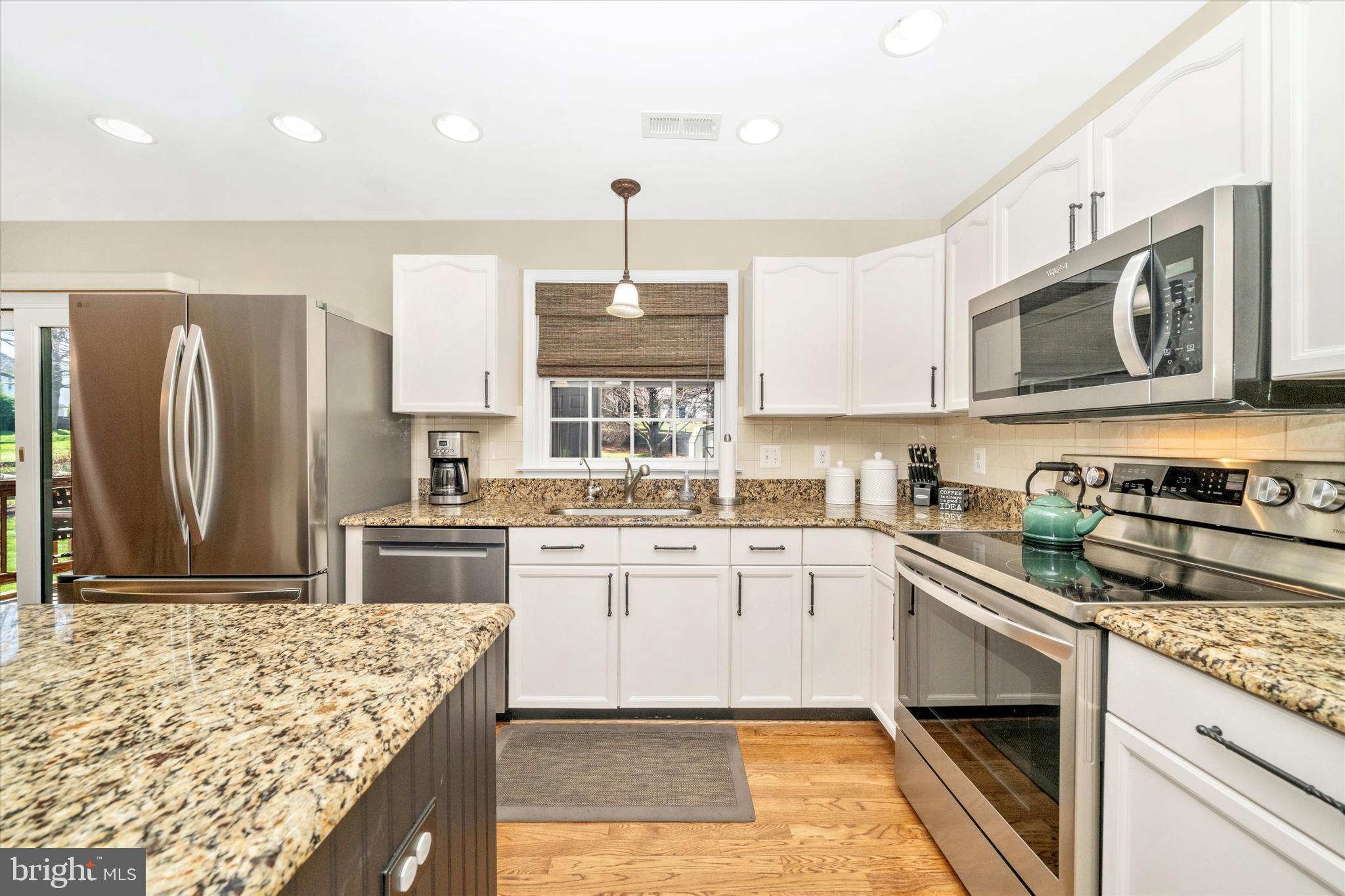 8321 Jordan Valley Way Frederick, MD 21702 - Photo 11 of 75 a kitchen with stainless steel appliances granite countertop a sink stove and refrigerator