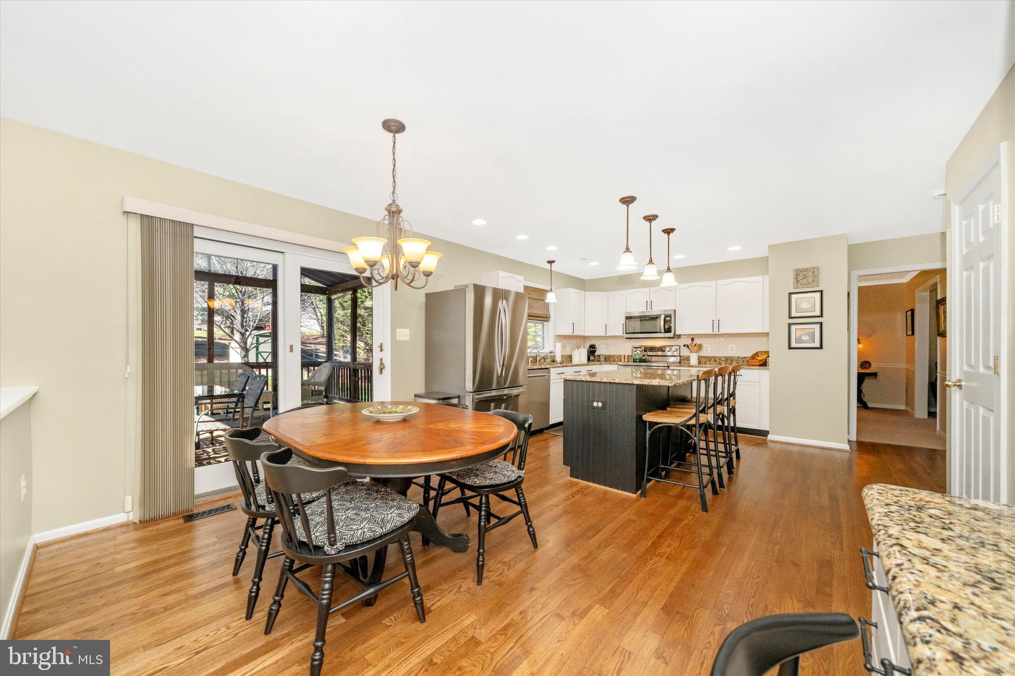 8321 Jordan Valley Way Frederick, MD 21702 - Photo 14 of 75 a dining room with furniture a chandelier and wooden floor