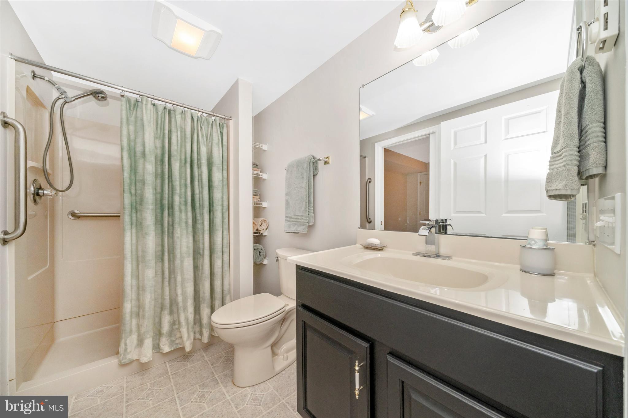 8321 Jordan Valley Way Frederick, MD 21702 - Photo 42 of 75 a bathroom with a granite countertop sink a toilet and shower