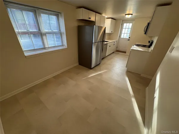 a view of a refrigerator in kitchen and wooden floor
