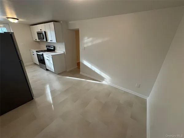 a kitchen with white cabinets and white appliances
