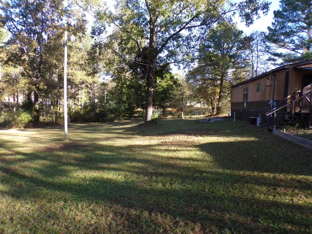 a view of the house with large trees