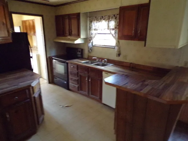 a kitchen with granite countertop a stove and a refrigerator
