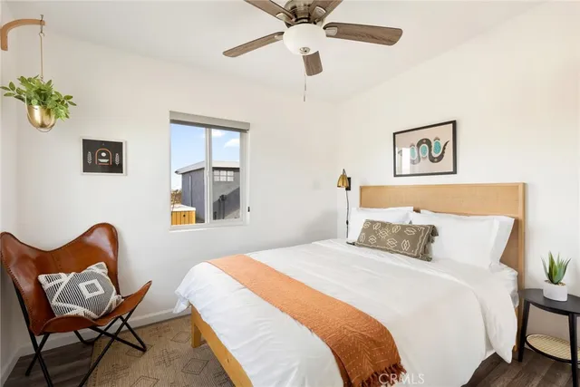 a bedroom with a bed and a chair