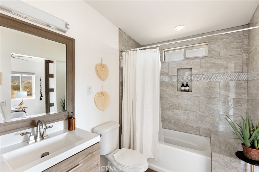 5737 Mojave Ranch Road Joshua Tree, CA 92252 - Photo 20 of 47 a bathroom with a sink toilet and shower