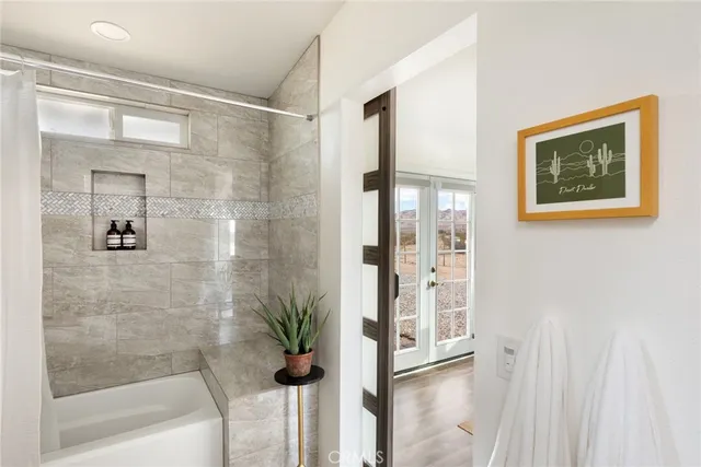 a bathroom with a shower and a bath tub
