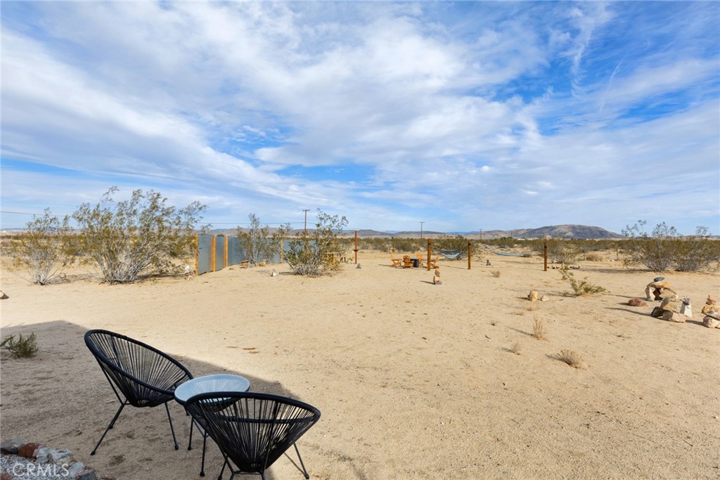 5737 Mojave Ranch Road Joshua Tree, CA 92252 - Photo 29 of 47 a view of a lake with a table under an umbrella