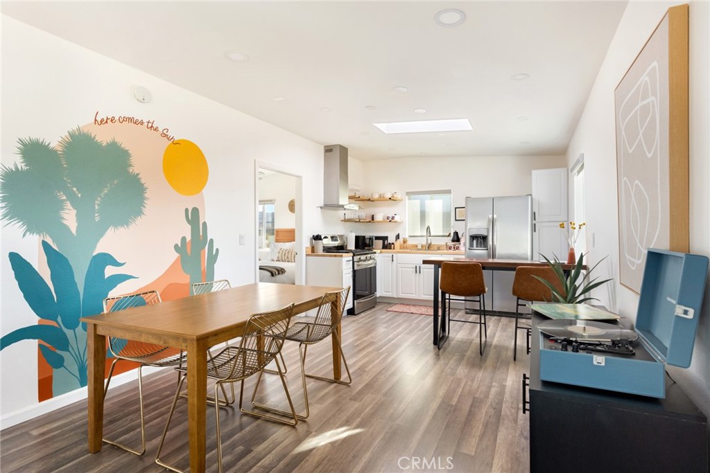 5737 Mojave Ranch Road Joshua Tree, CA 92252 - Photo 3 of 47 a living room with dining room and wooden floor