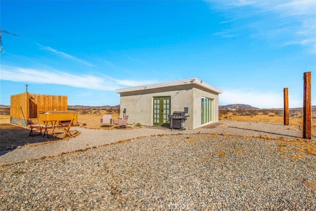 5737 Mojave Ranch Road Joshua Tree, CA 92252 - Photo 32 of 47 a view of a house with wooden floor and outdoor space