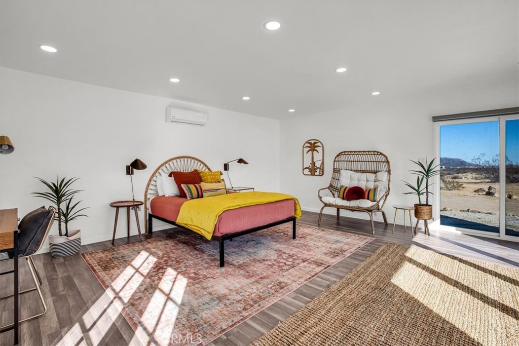 5737 Mojave Ranch Road Joshua Tree, CA 92252 - Photo 37 of 47 a bedroom with a bed and a chandelier