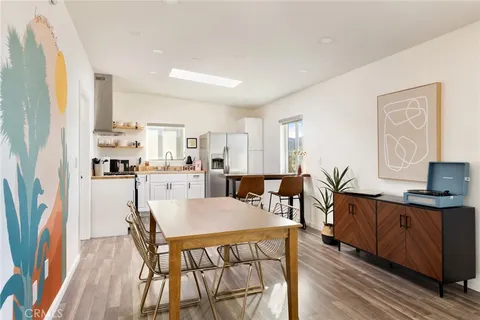 a view of a dining room with furniture and a wooden floor