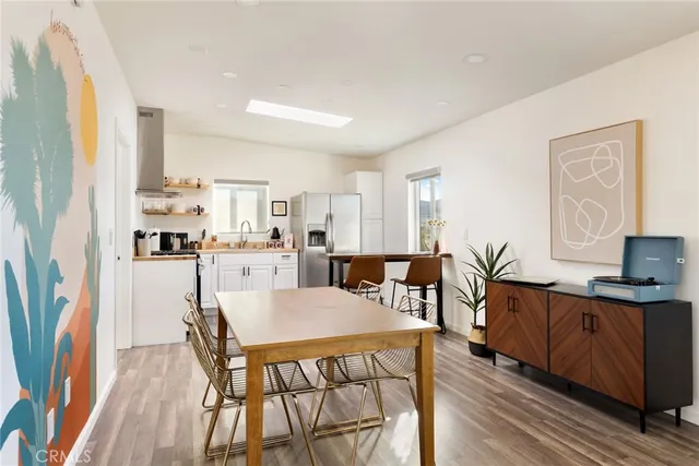 a view of a dining room with furniture and a wooden floor