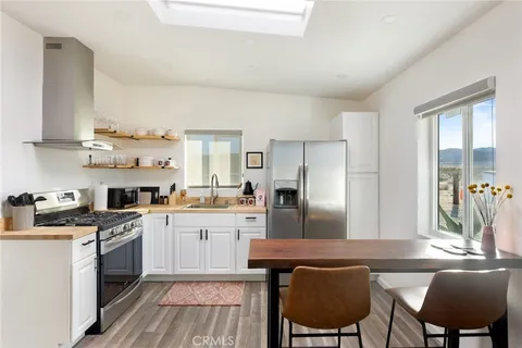 a kitchen with cabinets and chairs